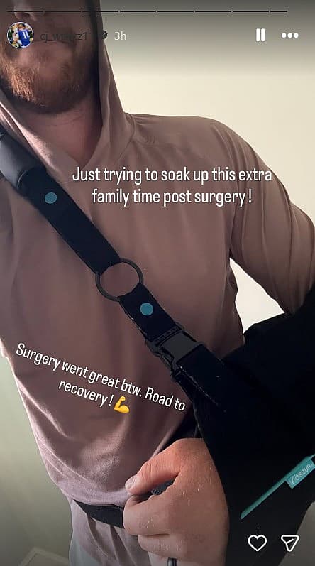 Carson Wentz in a hoodie adjusting a shoulder sling in a close-up Instagram Story photo.