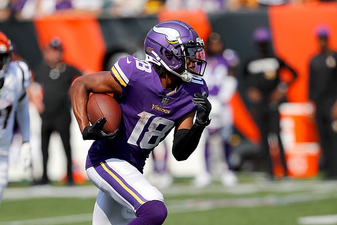 Justin Jefferson runs with the ball against the Bengals in overtime. Vikings wide receivers