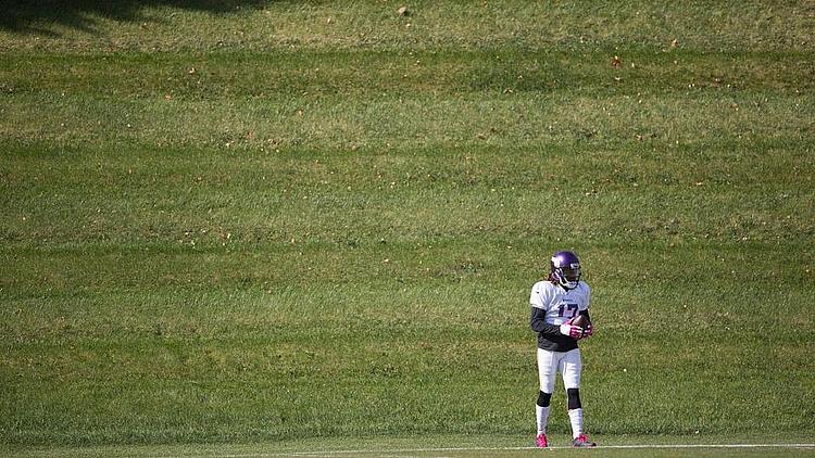 Vikings player stands alone in outfield during game.