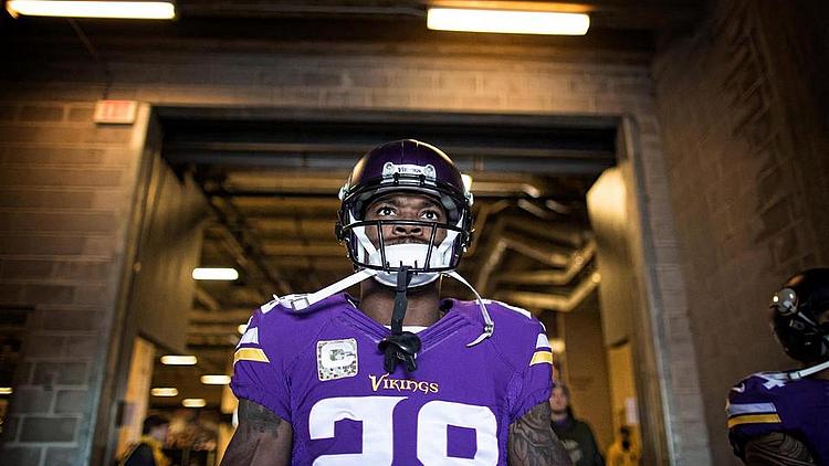Vikings player #28 in purple jersey in tunnel before game.