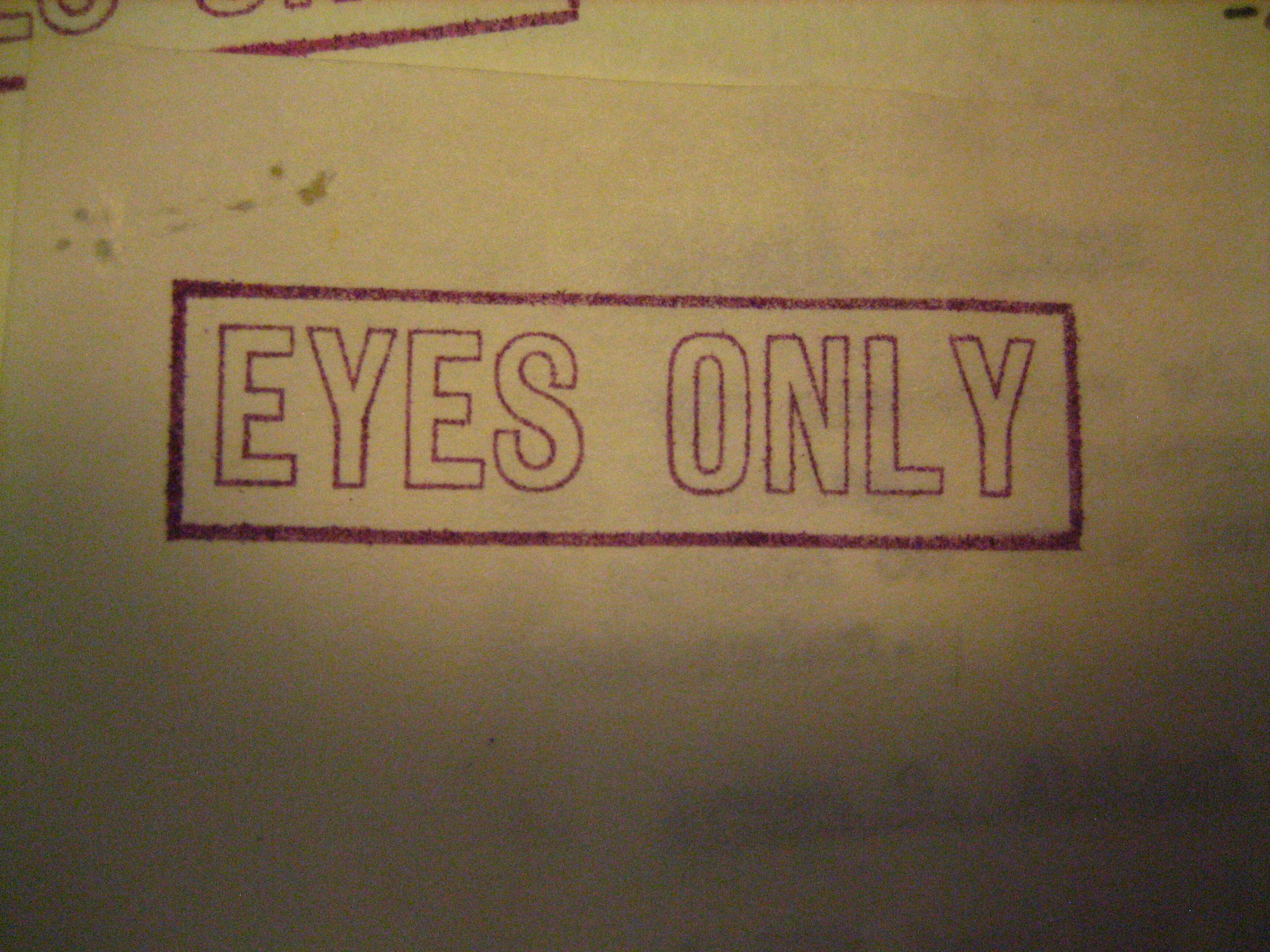 Red "EYES ONLY" stamp on aged beige background document.