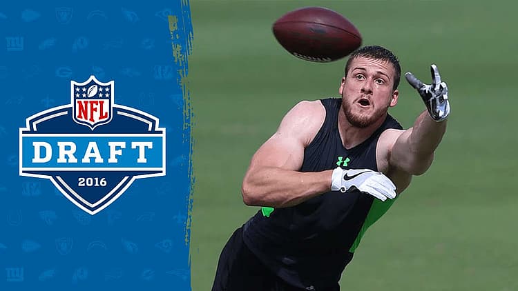 Player catches football at 2016 NFL Draft workout on green field.