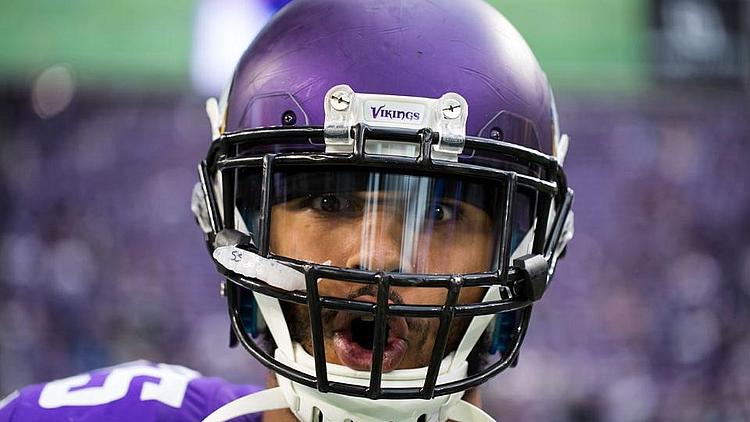 Minnesota Vikings player wearing purple jersey and helmet during game.