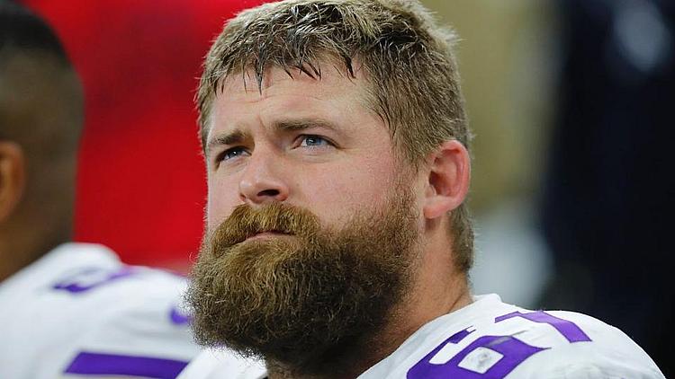 Bearded player in purple Vikings jersey during game.