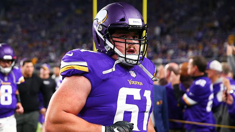 Minnesota Vikings player wearing number 61 purple jersey during game.