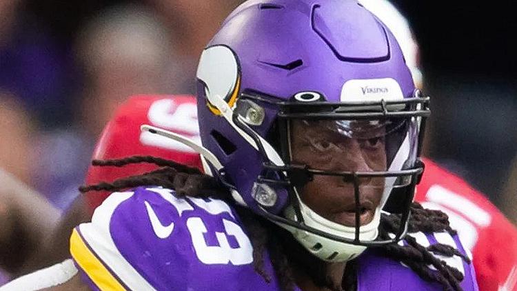Minnesota Vikings player in purple jersey during game action.