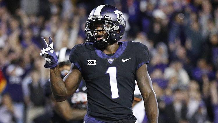 Football player wearing number 1 black jersey celebrates during game.