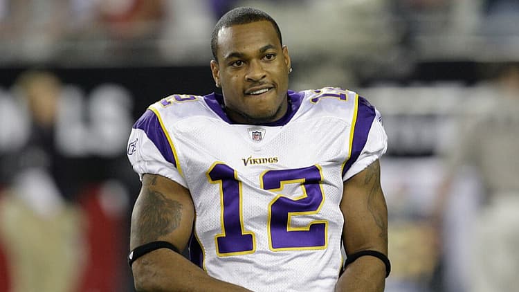 Minnesota Vikings player wearing number 12 white jersey on sideline.
