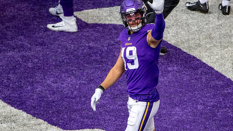 Adam Thielen waves toward empty seats before the game against Green Bay.
