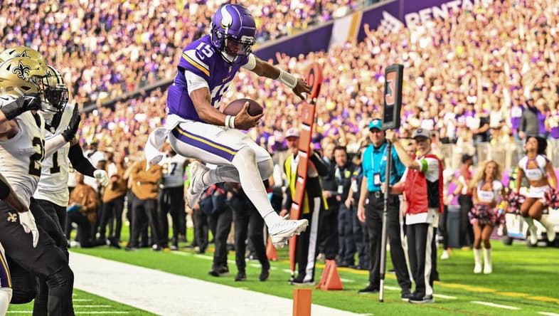 Joshua Dobbs scores a rushing touchdown during a Vikings game against the New Orleans Saints.