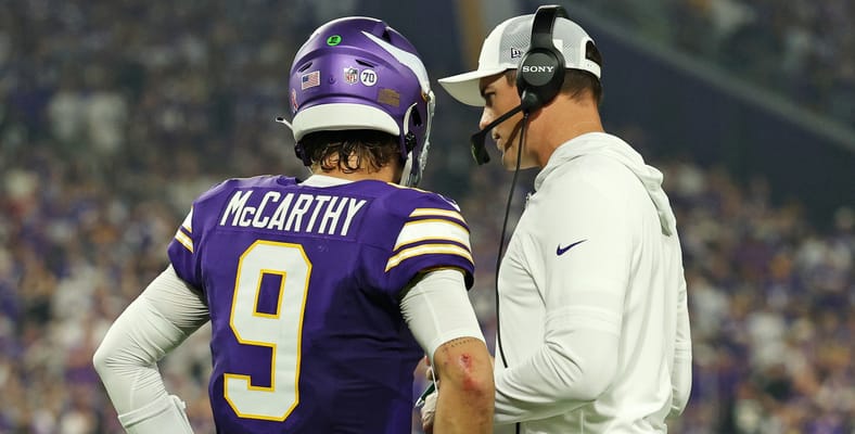 J.J. McCarthy talks with Kevin O’Connell on the Vikings sideline during the game against the Falcons.