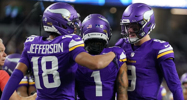 Jalen Nailor celebrates a touchdown with Justin Jefferson and J.J. McCarthy during a game against the Cowboys.