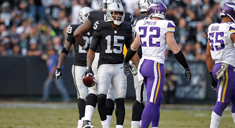 Michael Crabtree talks with Harrison Smith after a third-quarter catch during Vikings vs. Raiders in Oakland.