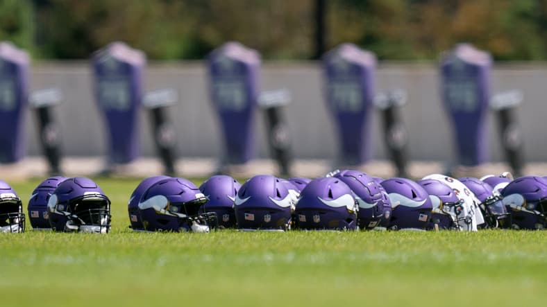 Vikings helmets in Eagan, MN. Vikings roster battles heat up at training camp.