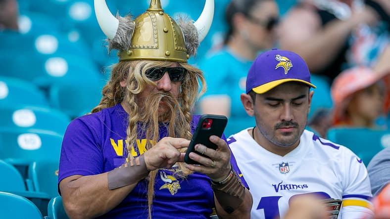 Minnesota Vikings fan raises support during the 2022 game against the Dolphins in Florida.