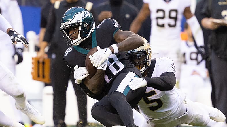 Jalen Reagor is tackled by Kwon Alexander after making a catch for the Eagles.