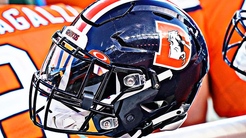 Denver Broncos helmet on sideline at Empower Field.