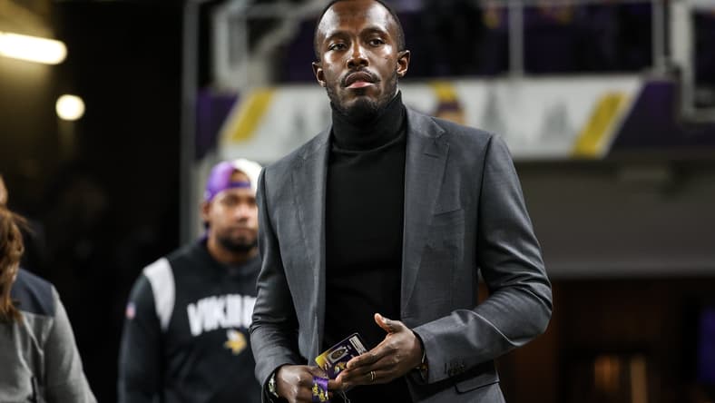 Kwesi Adofo-Mensah stands on the field before a Vikings game at U.S. Bank Stadium.