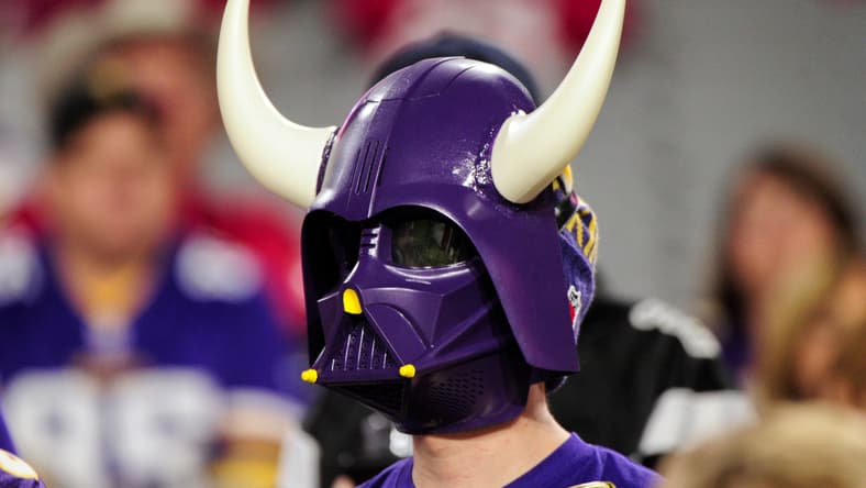 A Minnesota Vikings fan watches pregame activities before a road game against the Arizona Cardinals in Glendale, Arizona.