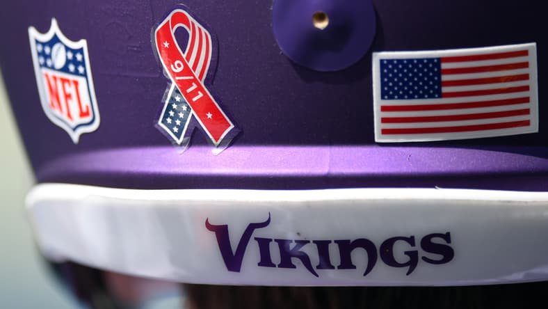 Close-up of a Vikings helmet with a 9/11 decal before a game against the Titans.