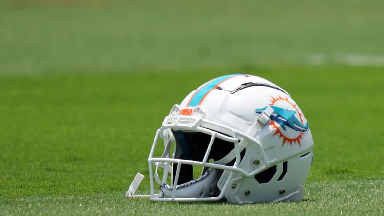 Miami Dolphins helmet on grass during OTA practice in Miami Gardens.