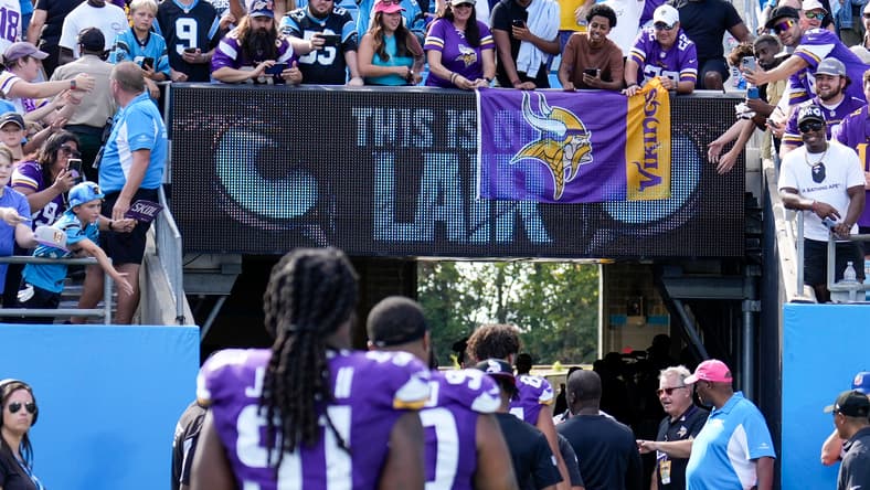 Vikings fans celebrate with custom signs after road win vs. Panthers.