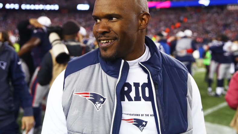 New England Patriots linebackers coach Brian Flores stands on the sideline before the AFC Championship Game against the Jacksonville Jaguars on Jan. 21, 2018.