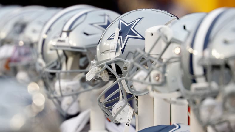 Dallas Cowboys helmets lined up on the bench at FedExField.