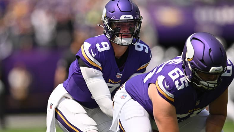 J.J. McCarthy and Michael Jurgens practice snaps during pregame warmups at U.S. Bank Stadium.