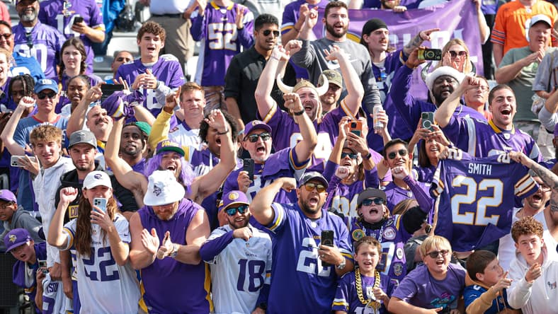Vikings fans celebrate along the lower bowl railing at MetLife Stadium following a road win in East Rutherford.