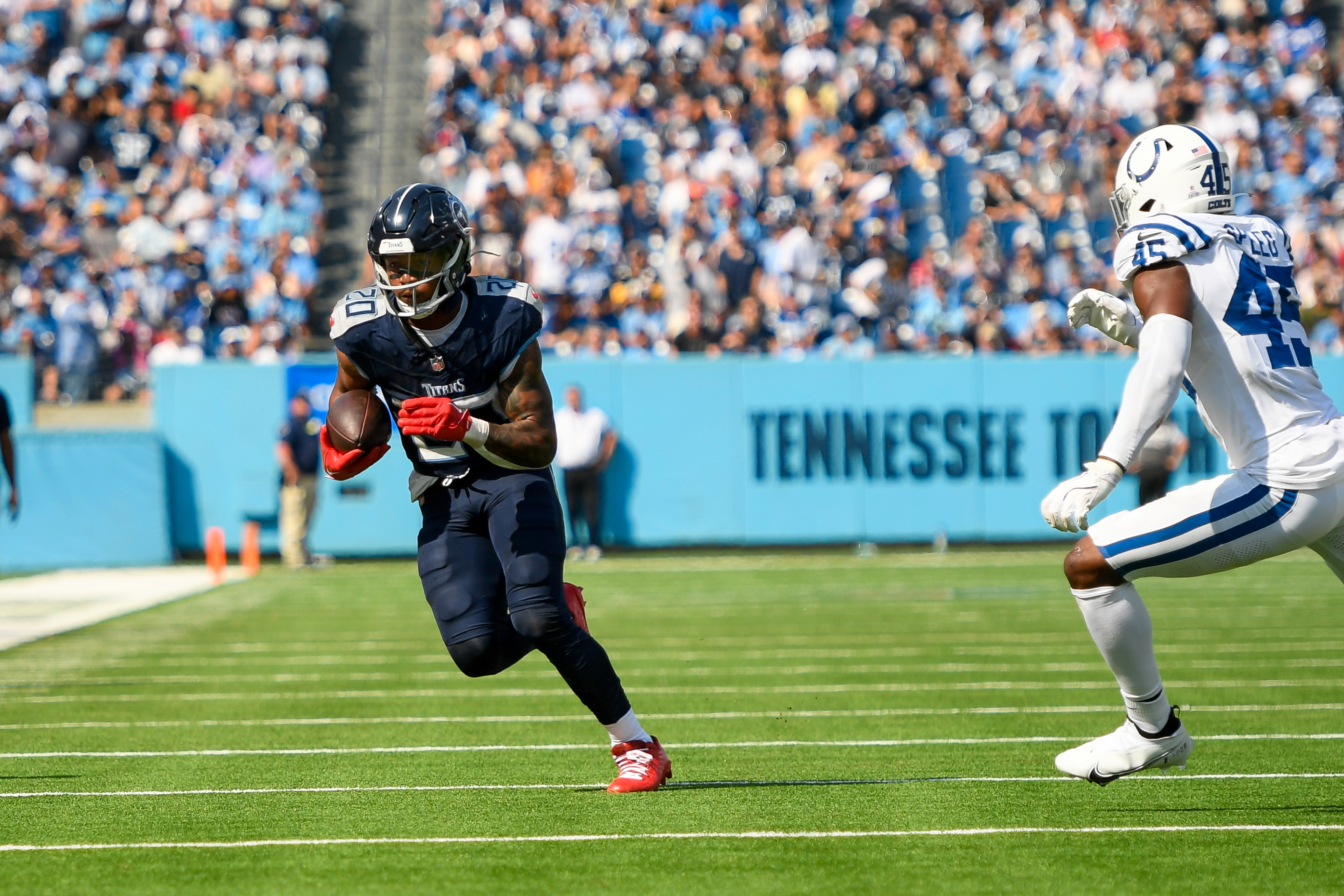 Titans running back Tony Pollard runs away from Colts linebacker E.J. Speed during a game in Nashville. Josh Jacobs