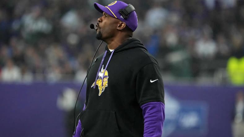 Vikings defensive coordinator Brian Flores watches from the sideline during a game at Tottenham Hotspur Stadium.