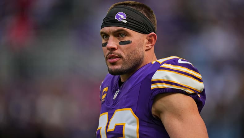 Minnesota Vikings safety Harrison Smith stands on the field at U.S. Bank Stadium before a game, wearing his helmet and uniform during pregame preparations.