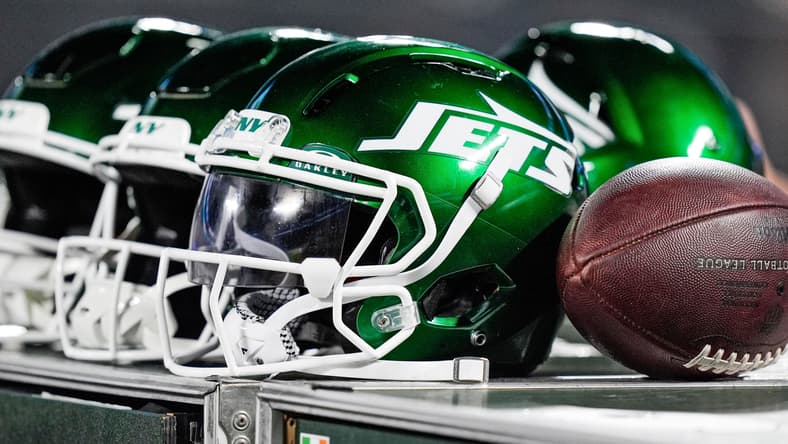New York Jets helmets sit along the sideline during a preseason game against the Carolina Panthers at Bank of America Stadium.