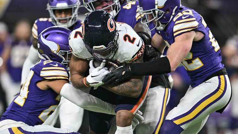 DJ Moore is tackled by Vikings safeties Harrison Smith, Camryn Bynum, and Josh Metellus during a fourth-quarter play at U.S. Bank Stadium.