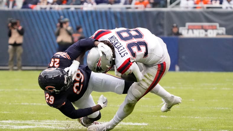 Tyrique Stevenson attempts to tackle Rhamondre Stevenson during a Bears-Patriots game. NFL predictions