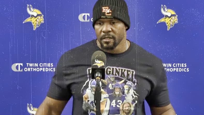 Brian Flores speaks with reporters after a Vikings win over the Cardinals during the 2024 season.
