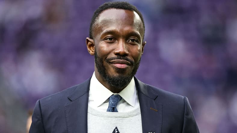 Vikings general manager Kwesi Adofo-Mensah stands on the field at U.S. Bank Stadium before a game against the Falcons.