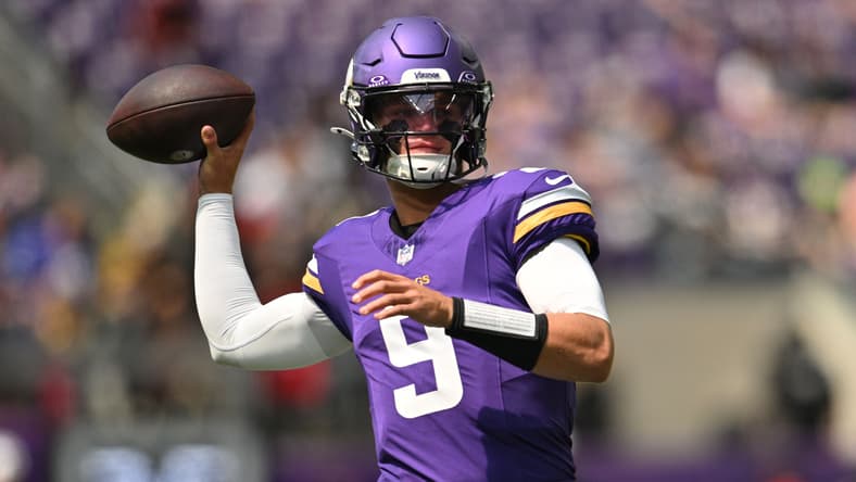 J.J. McCarthy throws during pregame warm-ups before the Vikings-Raiders game in Minneapolis.