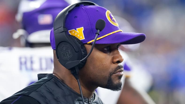 Brian Flores watches from sideline during Vikings playoff game vs. Rams.