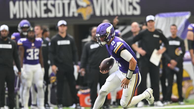 J.J. McCarthy scrambles with the football during a preseason game against the Las Vegas Raiders at U.S. Bank Stadium.