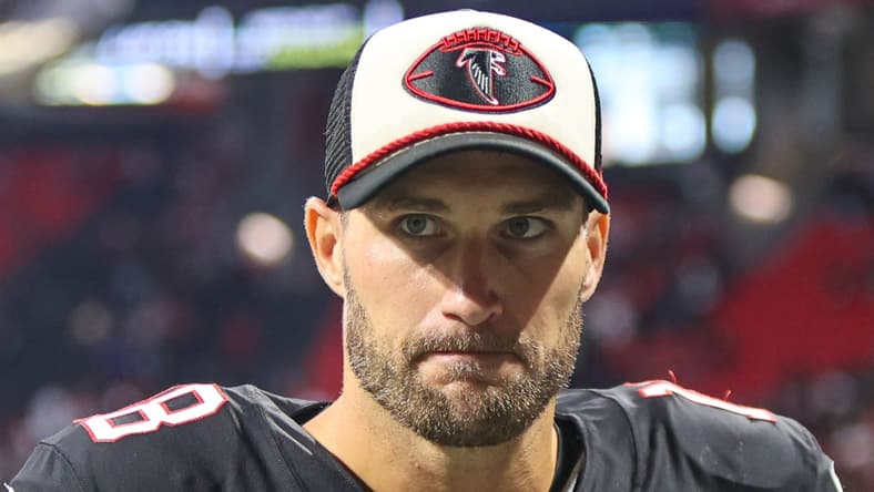 Kirk Cousins walking off the field at Mercedes-Benz Stadium after a Falcons game.