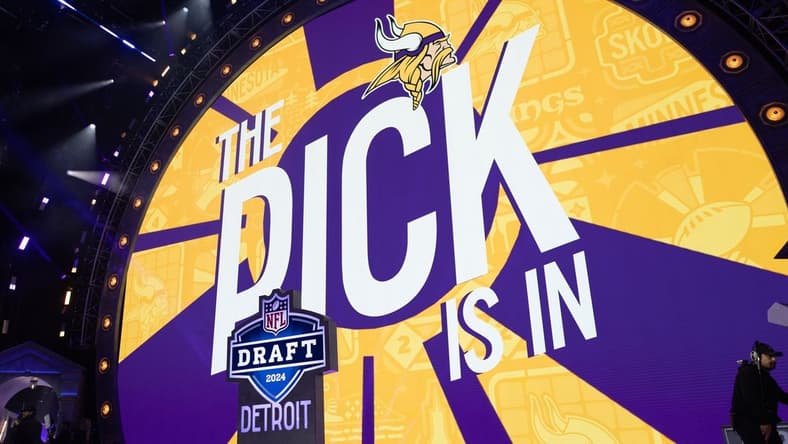 Jordan Addison stands on stage after being drafted by the Vikings in the first round.