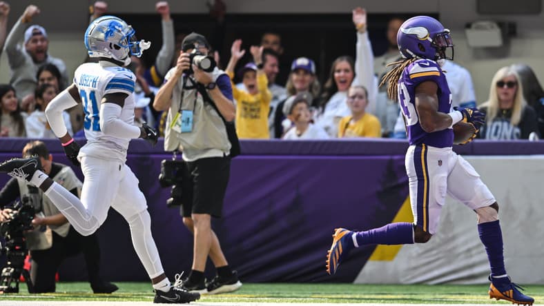 Aaron Jones scores a rushing touchdown for the Vikings against the Lions. Vikings contract extensions