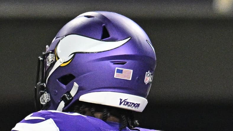 Sam Darnold and Cam Akers celebrate a touchdown against the Packers on Dec. 29, 2024, at U.S. Bank Stadium.