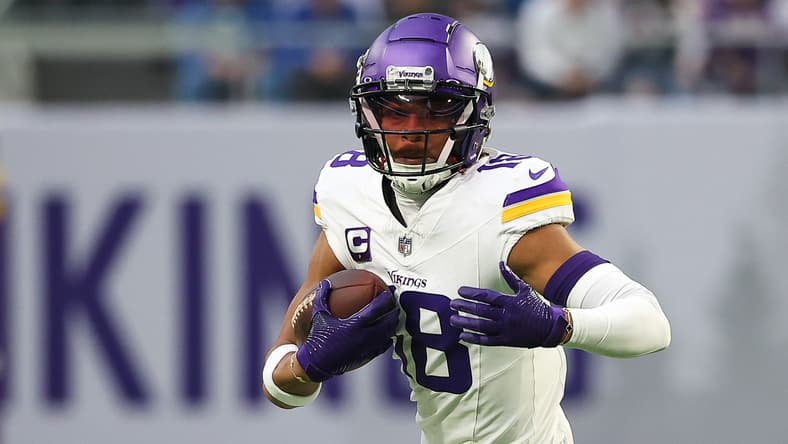 Justin Jefferson runs after a catch during a Vikings game against the Detroit Lions.
