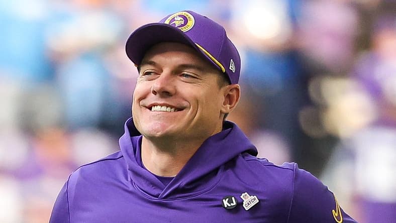 Kevin O’Connell runs onto the field before a Vikings game against the Detroit Lions.