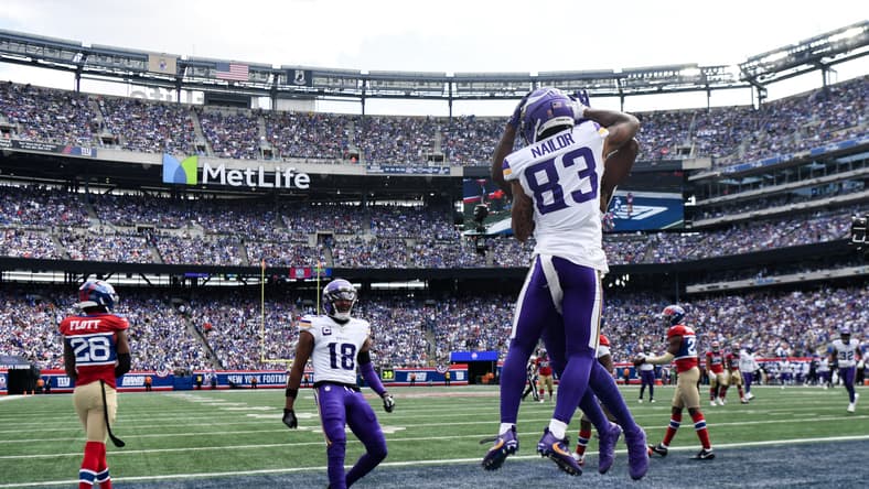 Jalen Nailor celebrates a touchdown with Vikings teammates.