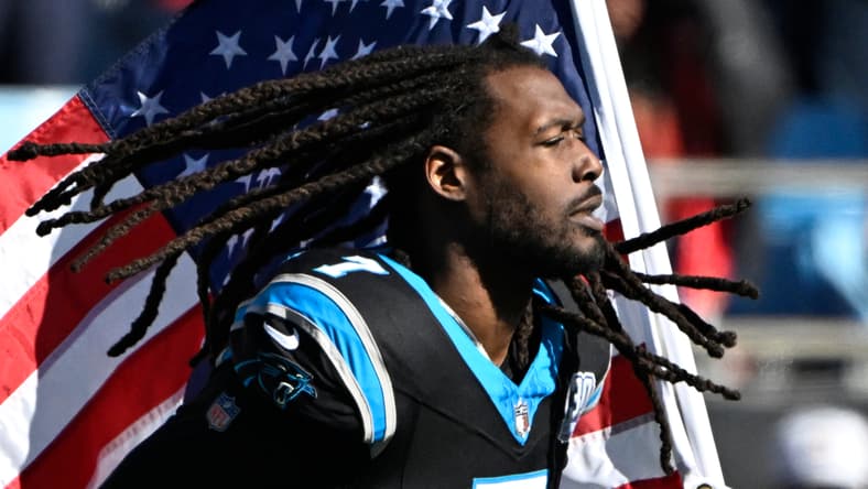 Jadeveon Clowney runs onto the field with an American flag before a Panthers game. Jonathan Greenard trade