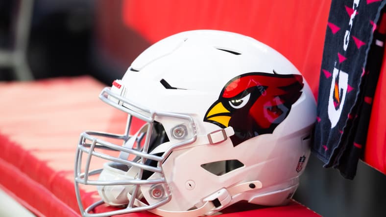 Close-up view of Arizona Cardinals helmet on sideline at State Farm Stadium.
